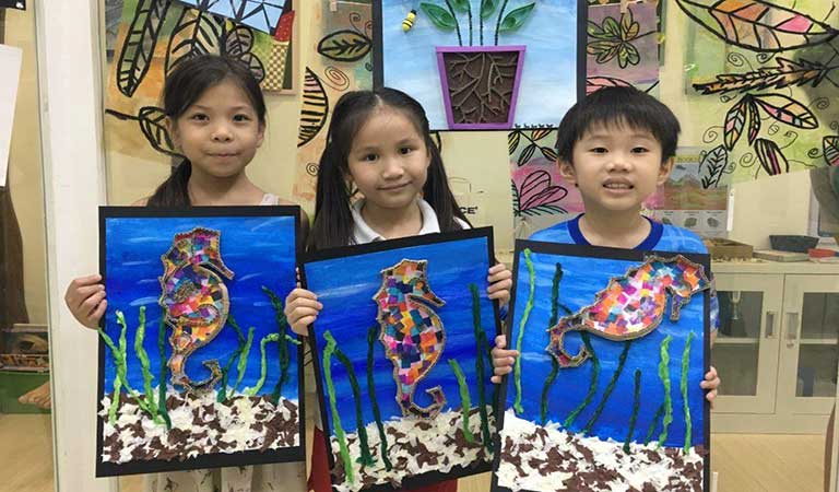 Danya, Isabelle and Jarrett created their seahorse art piece with cardboard and collage!