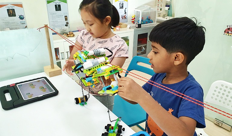 Testing their codes to make their LEGO Monorail move.